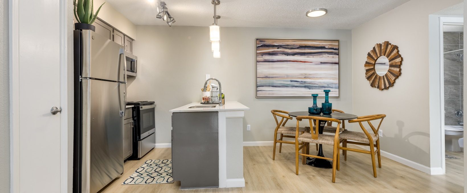 a kitchen and dining area with hardwood floors at The Winslow
