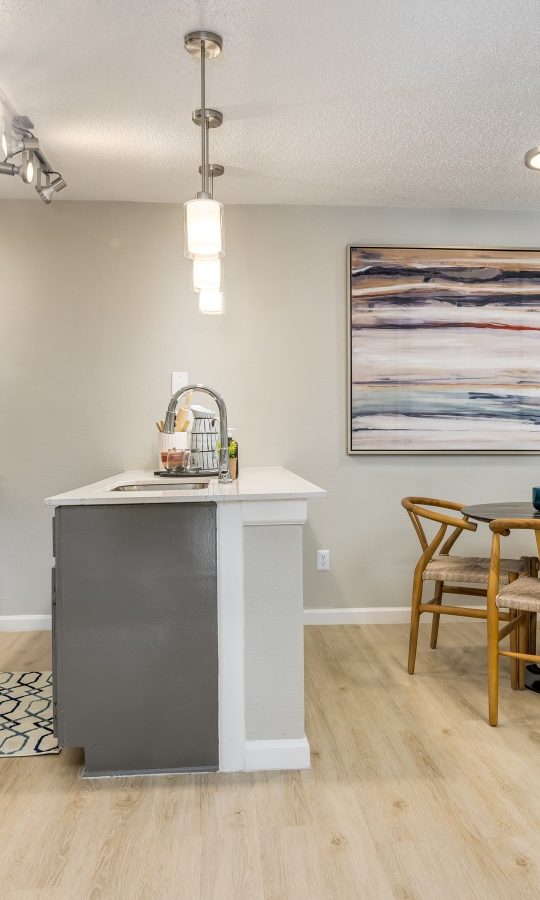 a kitchen and dining area with hardwood floors at The Winslow
