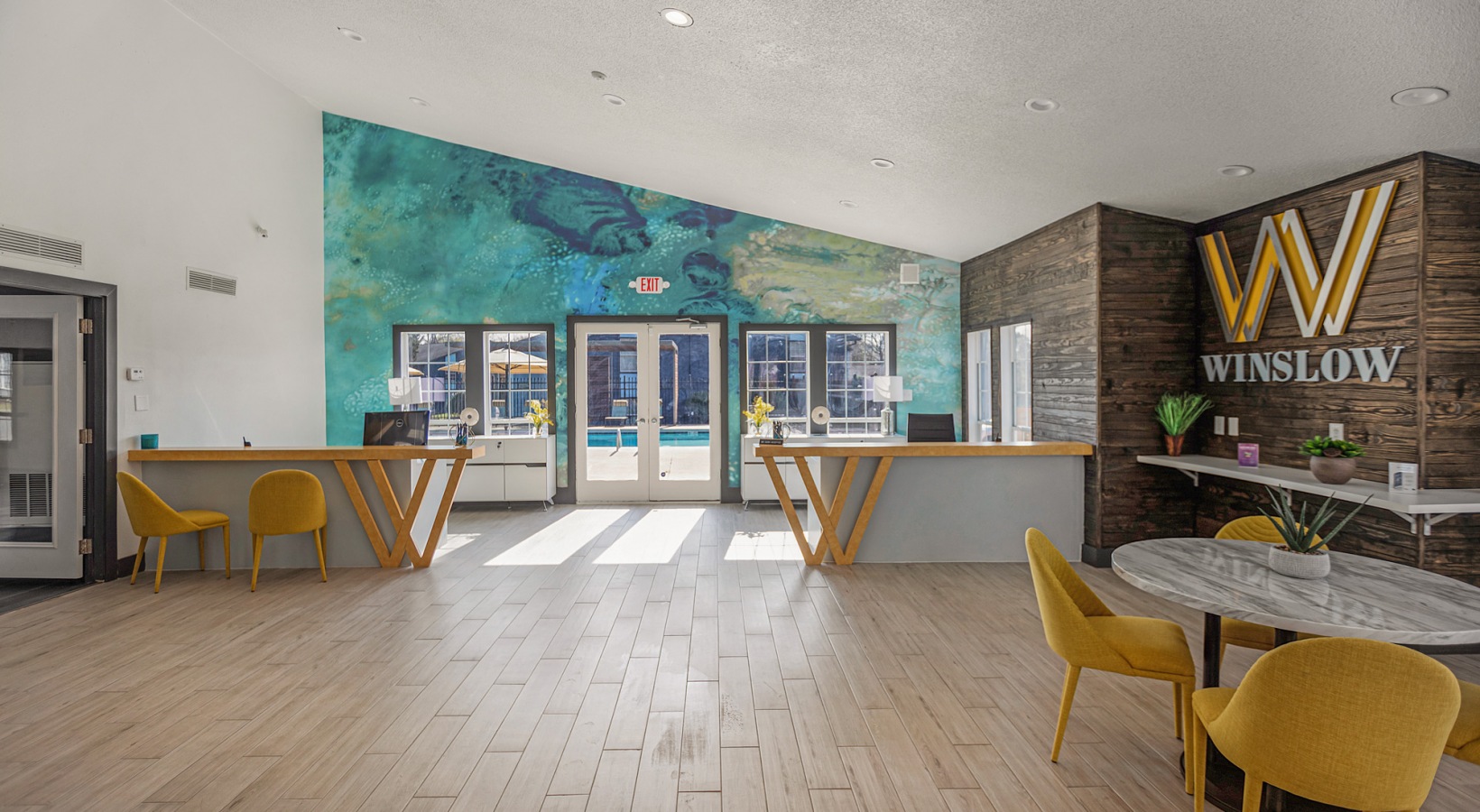 the lobby of a hotel with a large mural on the wall at The Winslow