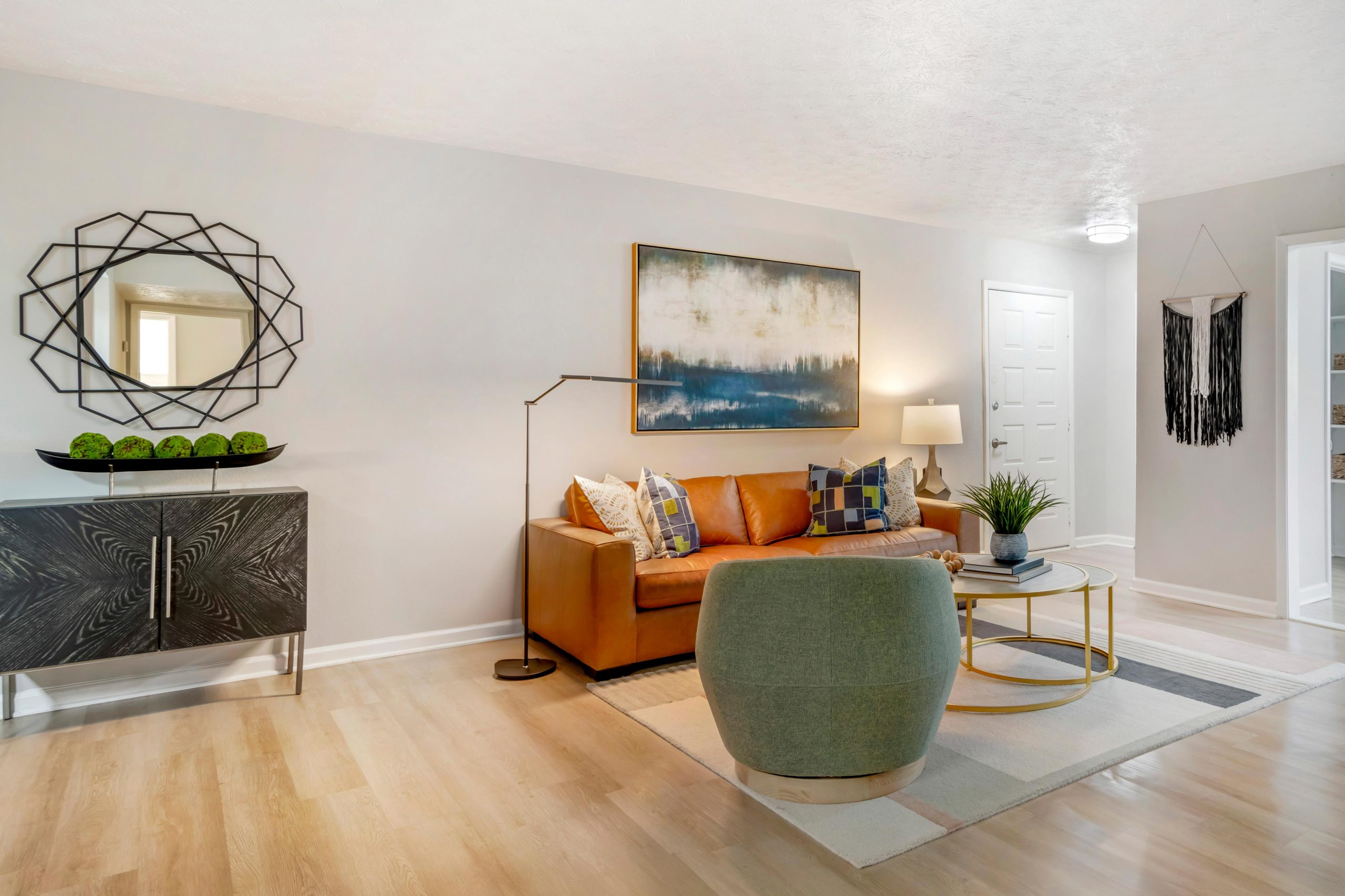 a living room with a couch, coffee table and a mirror at The Bowie