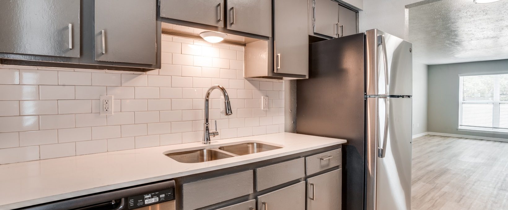 a kitchen with stainless steel appliances and a sink at The Melville