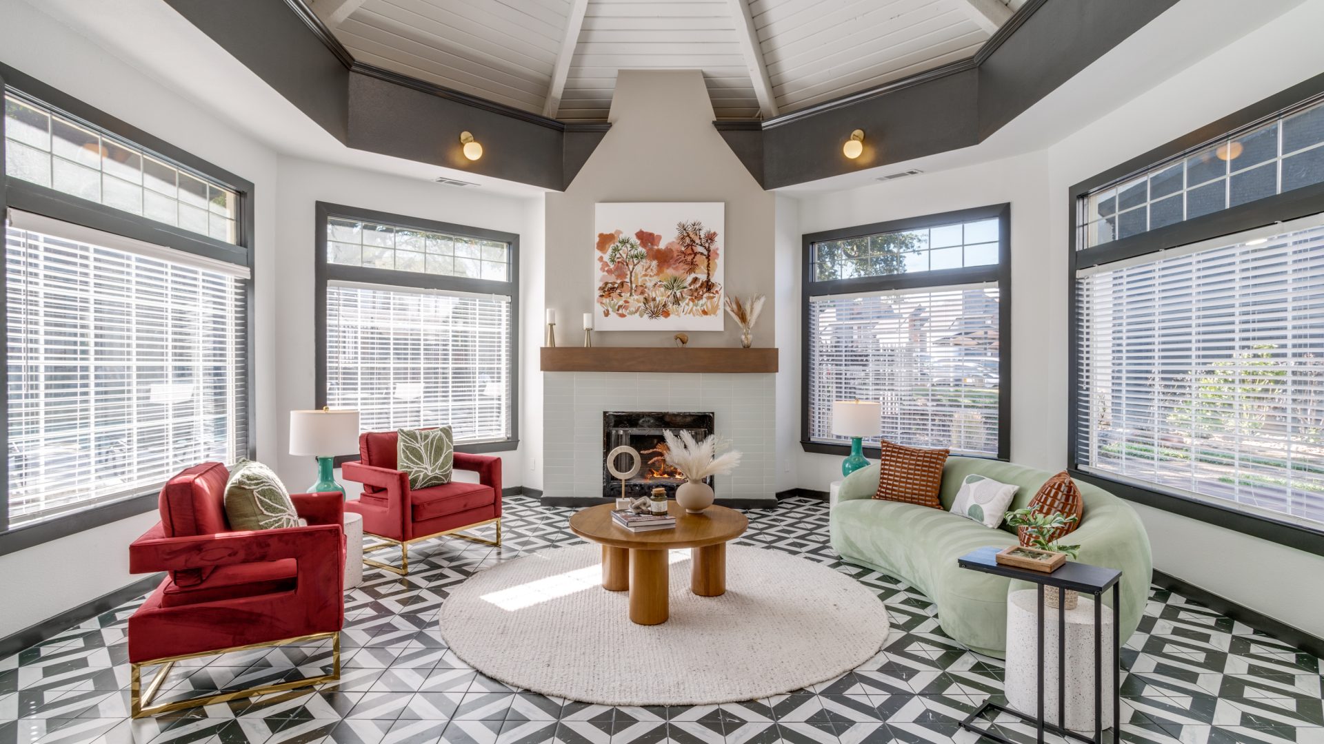 a living room with a fireplace and black and white tile at The Evaline