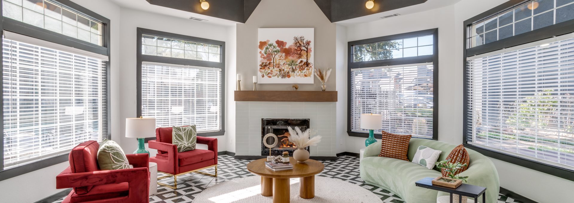 a living room with a fireplace and black and white tile at The Evaline