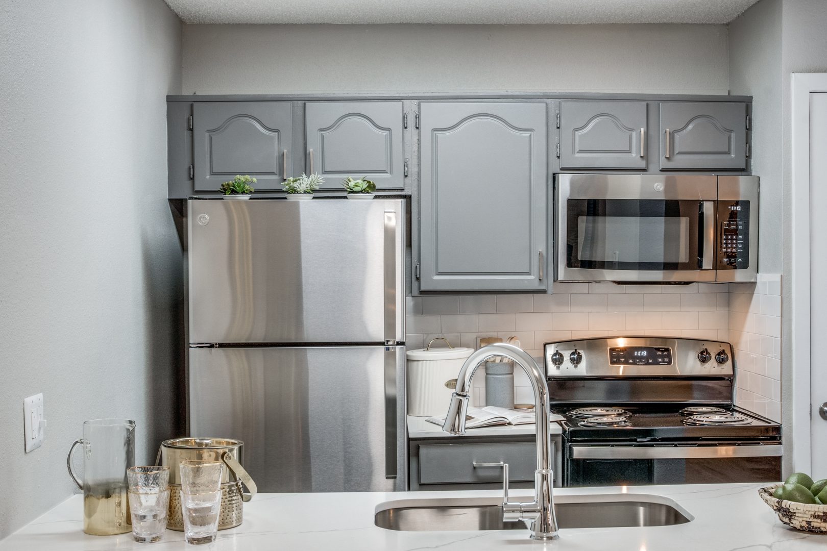 kitchen with stainless steel appliances and silver cabinets at The Evaline