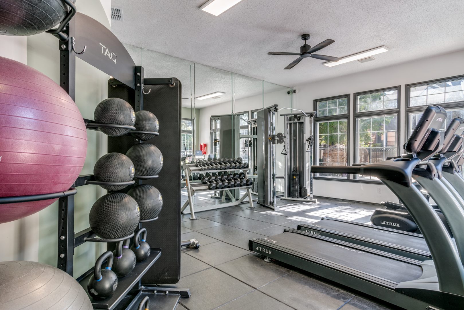 a gym room with exercise equipment and mirrors at The Evaline