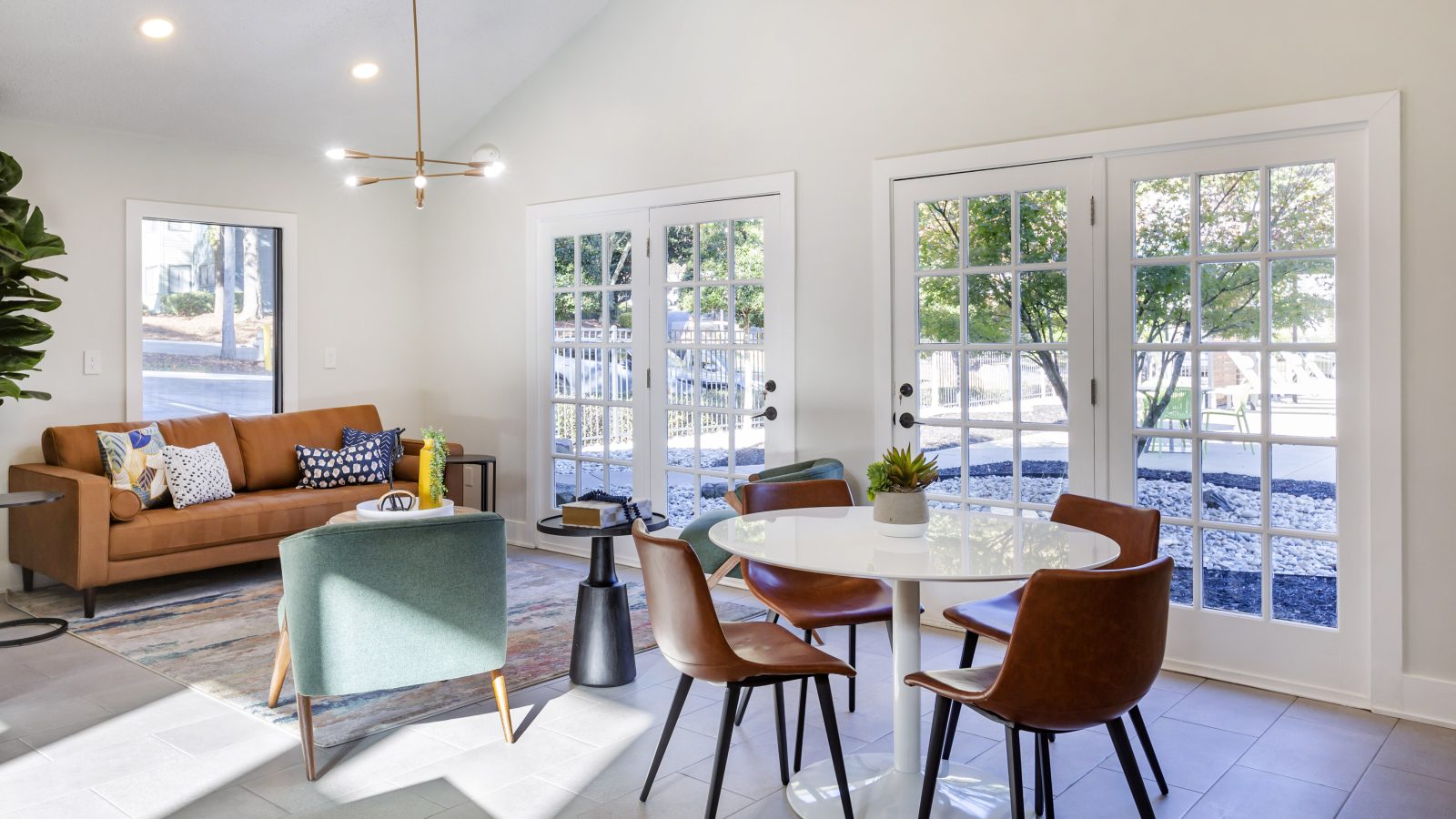 a living room with a dining table and chairs at The Terra at Norcross