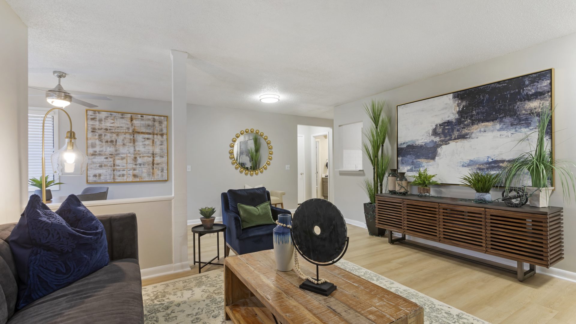 a living room with a couch, coffee table and fan at The Terra at Norcross