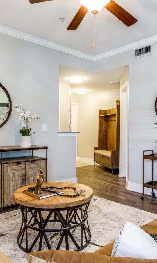 the living room has a ceiling fan and a couch at The Ellwood at Lake Travis