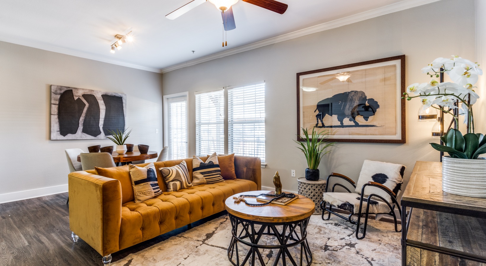 the living room has a brown couch and a yellow rug at The Ellwood at Lake Travis