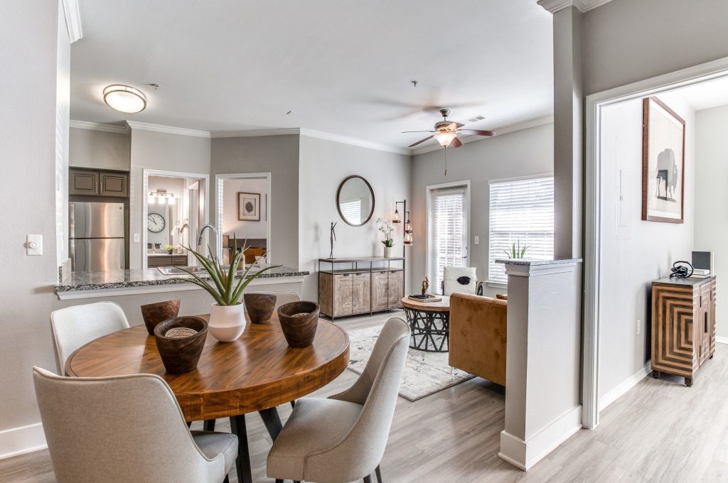 the dining room and kitchen area of a home at The Ellwood at Lake Travis