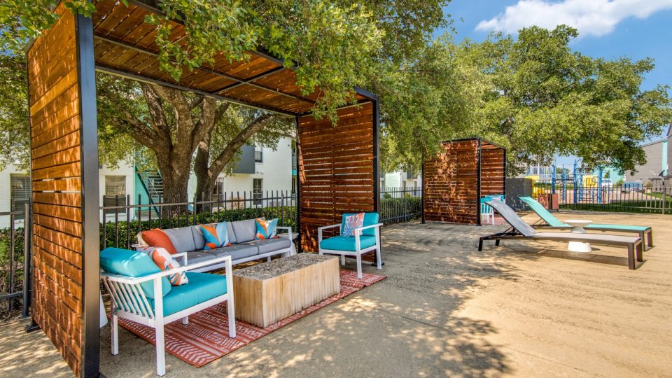a patio with lounge chairs and a table at The  Booker