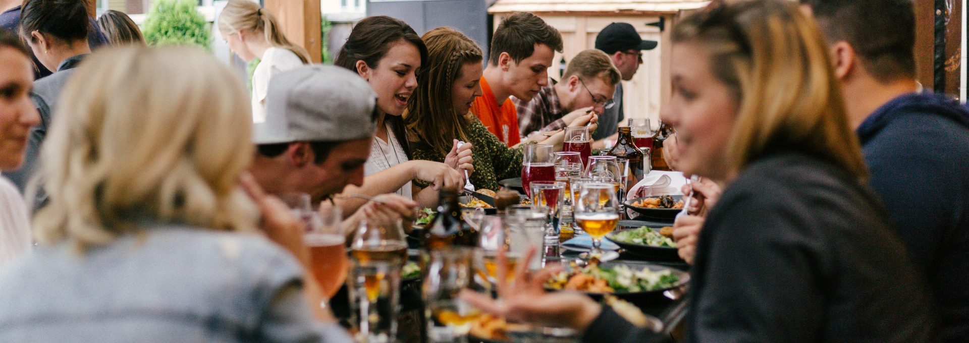 people sitting in front of table talking and eating