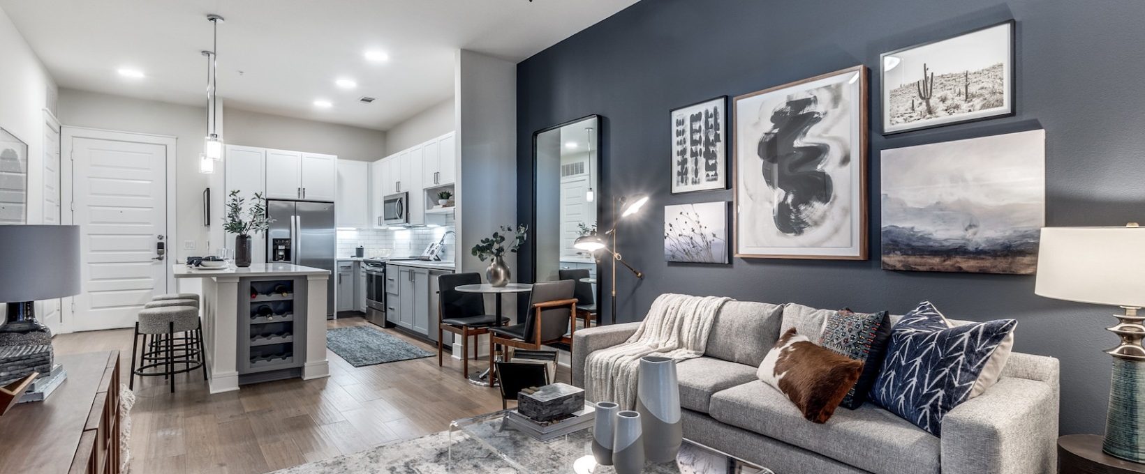 a living room with blue walls and gray furniture at The Teak at  Branch
