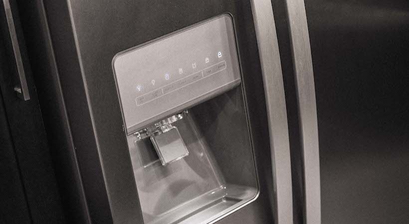 a black refrigerator with a water dispenser at The Teak at  Branch
