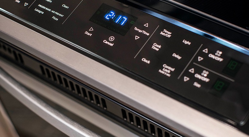 a close up of a digital clock on a stove at The Teak at  Branch