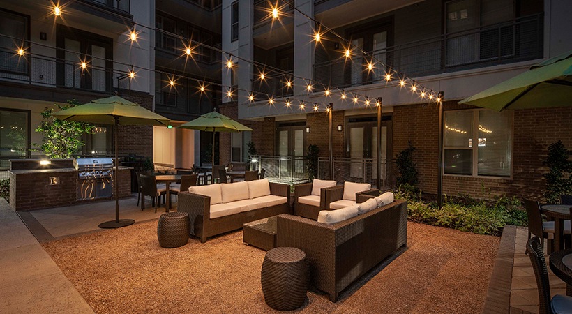 outdoor seating area with string lights and patio furniture at The Ash at  Branch