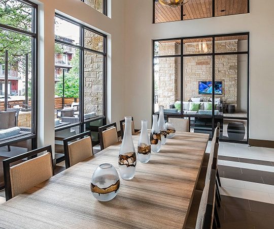 a dining room with large windows and a large table at The Ash at  Branch