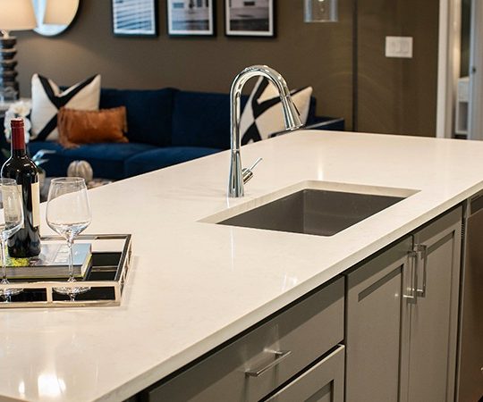 a kitchen with a white counter top and sink at The Ash at  Branch