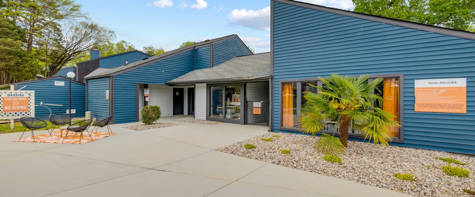 the exterior of a building with blue siding and a sign that says, at The  Tatum