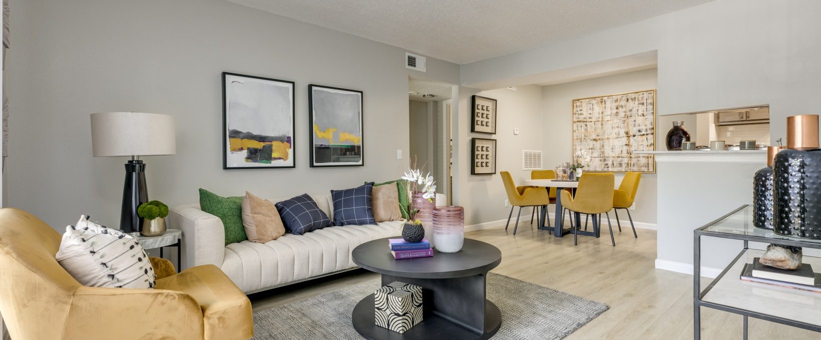 a living room with a couch, coffee table and chairs at The  Tatum