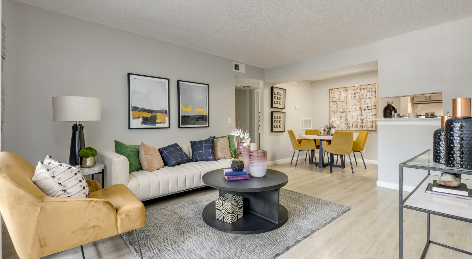 a living room with a couch, coffee table and chairs at The  Tatum