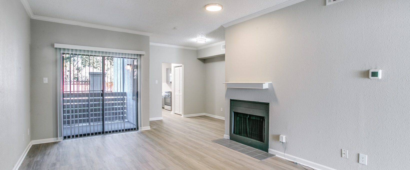empty living room with hardwood floors and fireplace at The Grant Valley Ranch