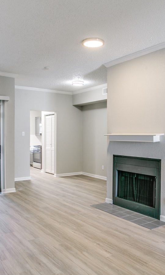 empty living room with hardwood floors and fireplace at The Grant Valley Ranch