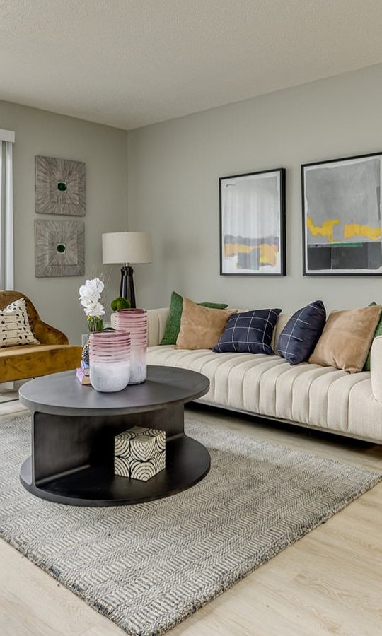 a living room with a couch, coffee table and television at The Grant Valley Ranch