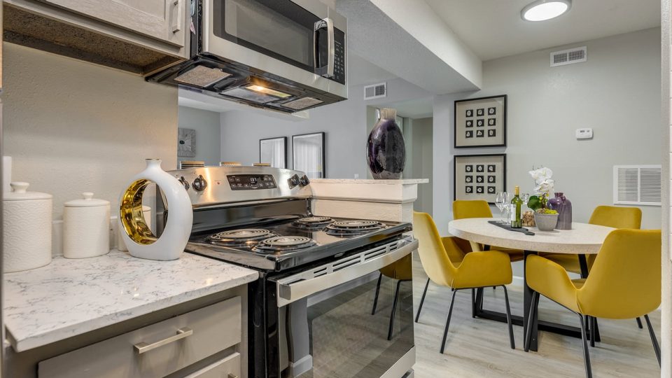 kitchen with stainless steel appliances and yellow chairs at The Grant Valley Ranch