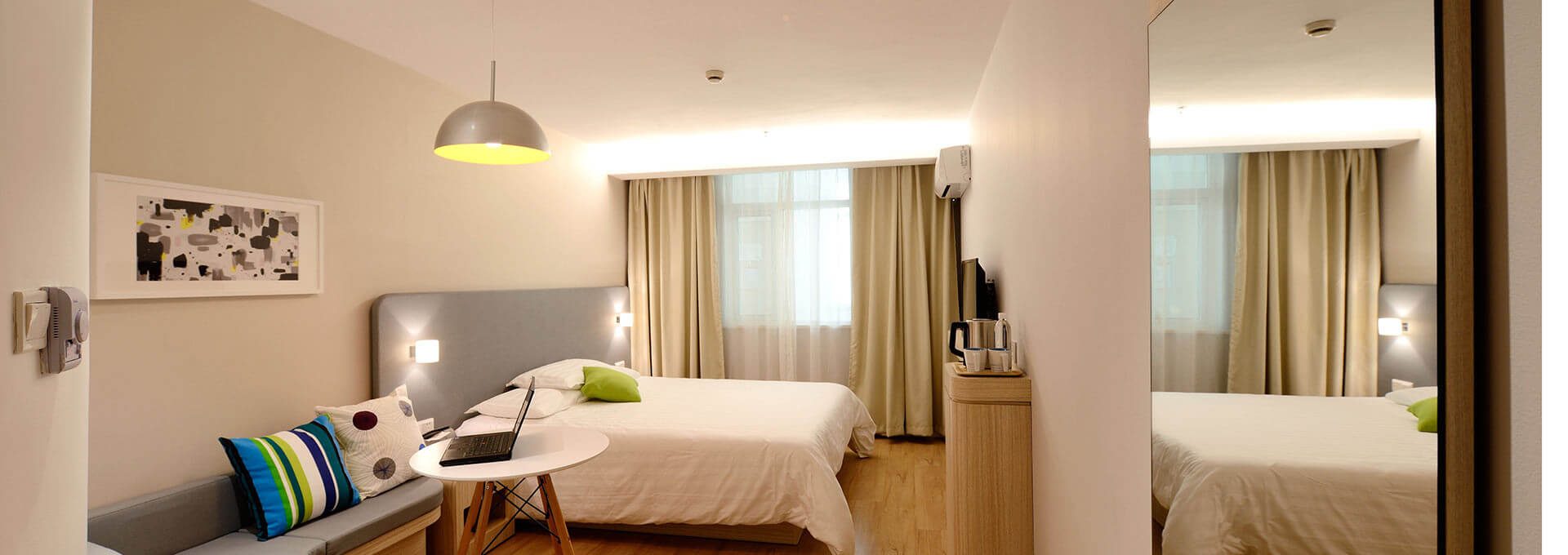 a hotel room with two beds and a desk at The Senara