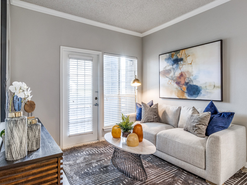 a living room with a couch, coffee table and a painting at The  Kendrick