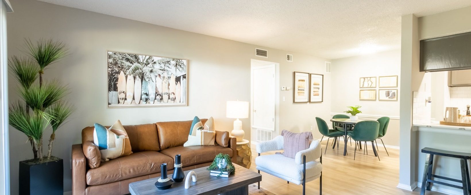 a living room with a couch, coffee table and chairs at The  Rowen