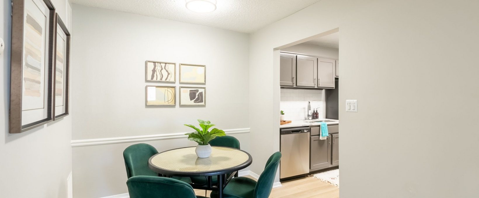 a dining room with a table and chairs and a kitchen at The  Rowen