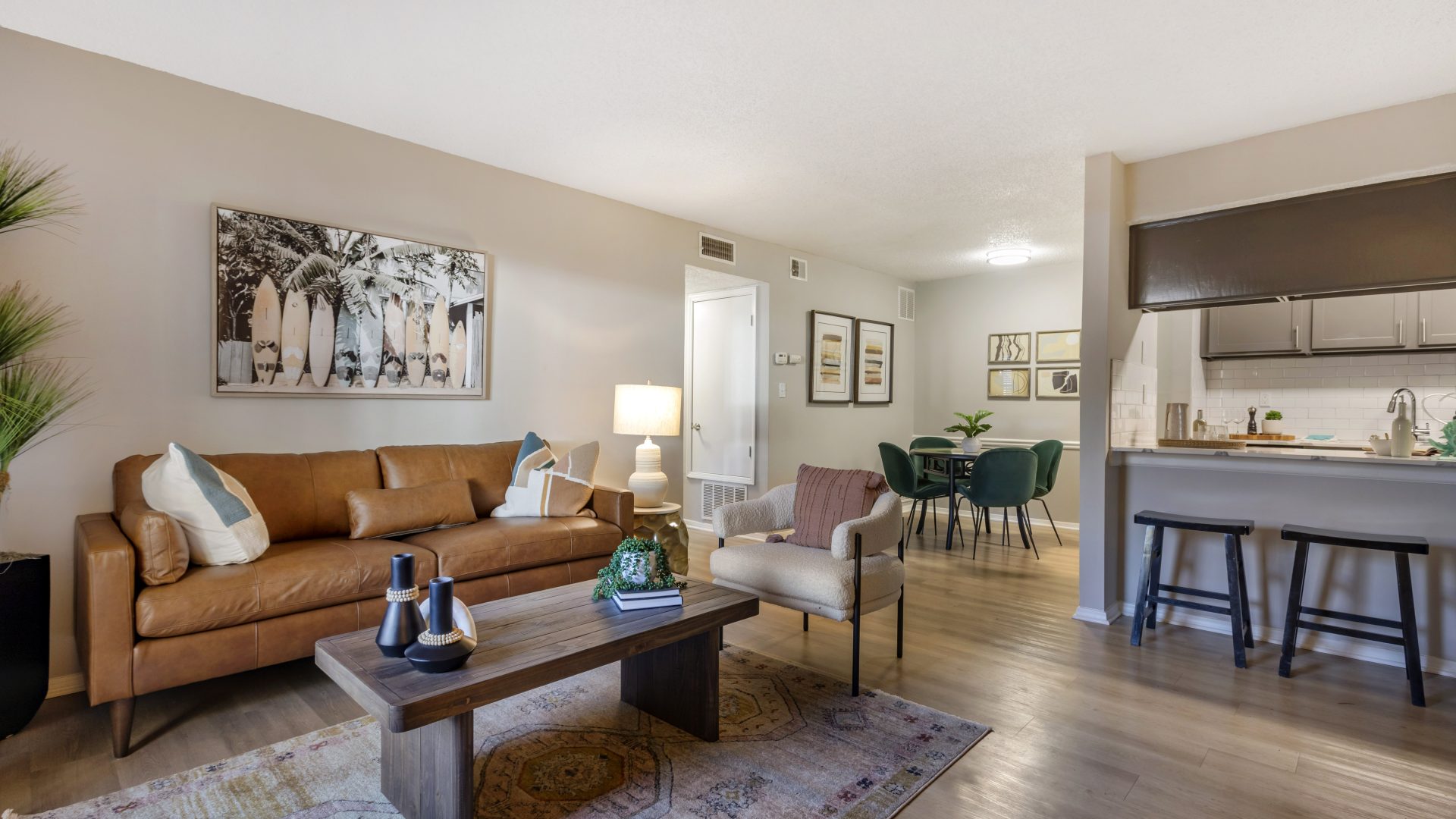 a living room and kitchen area with a couch and coffee table at The  Rowen