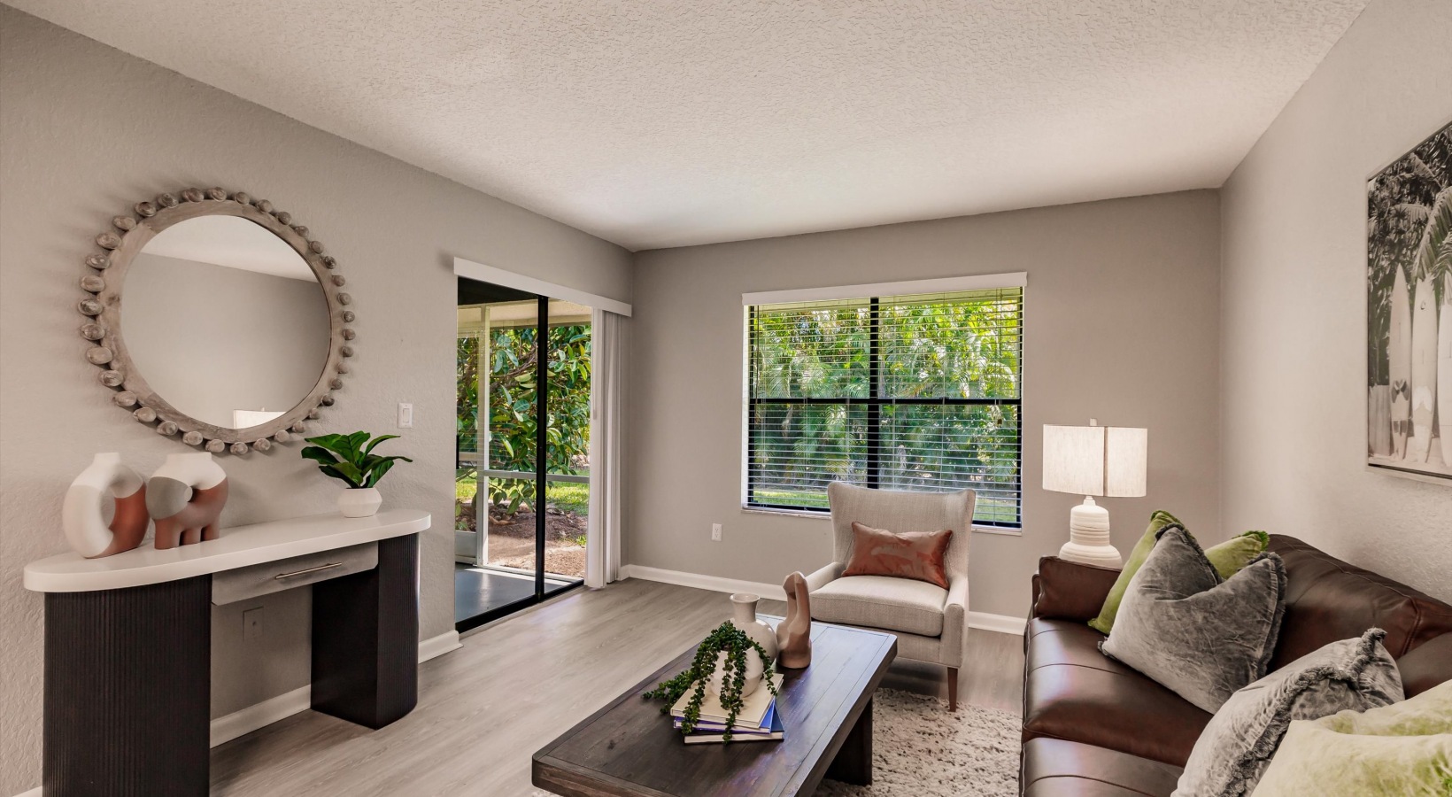 a living room with a couch, coffee table and television at The Marino