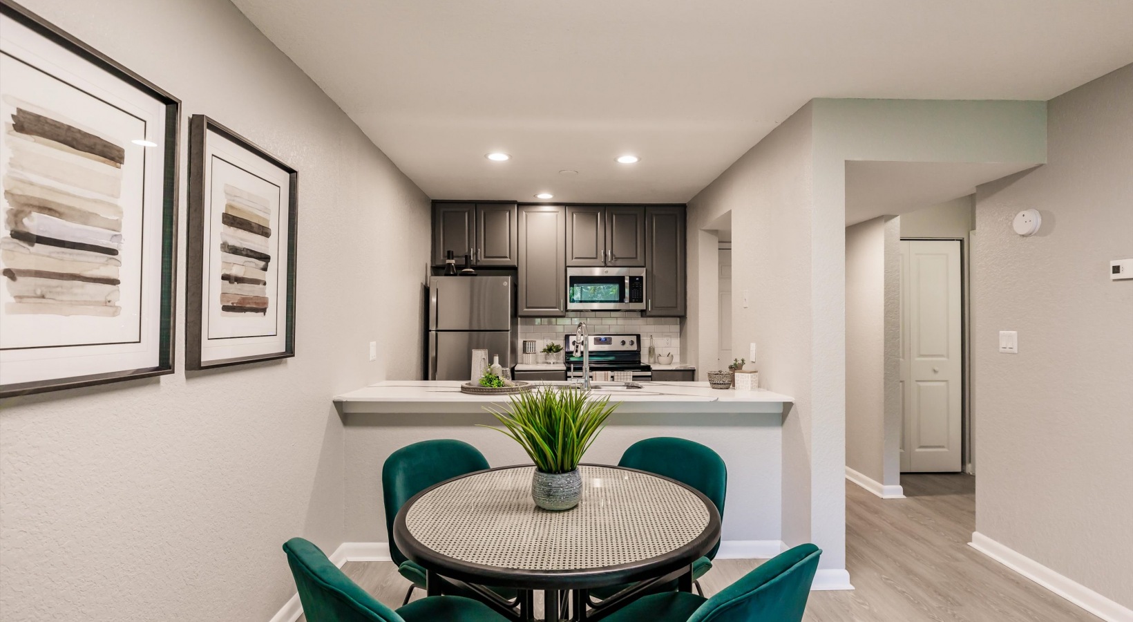 a kitchen and dining area with a green table at The Marino