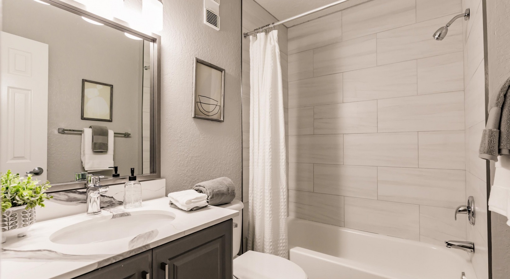 a bathroom with a tub and toilet and sink at The Marino