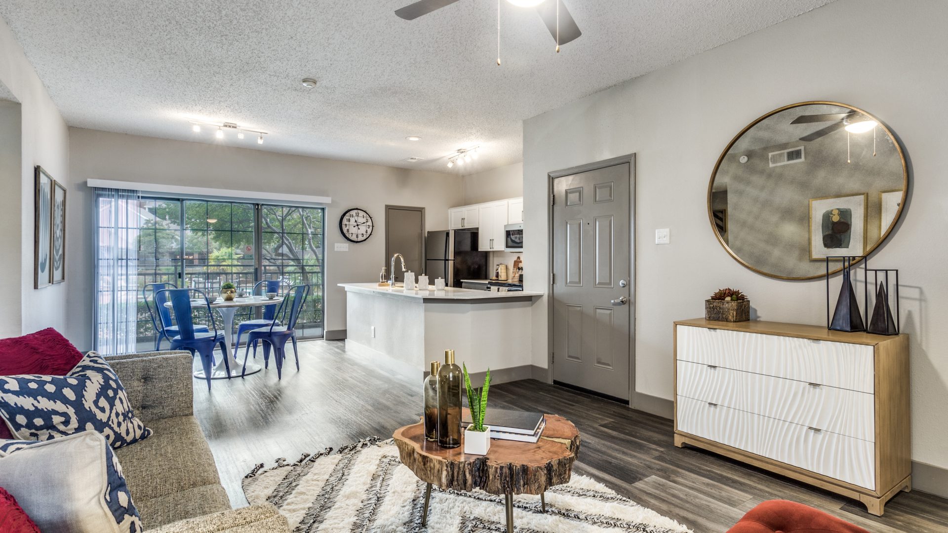 the living room and kitchen area of a home at The Hyde Park at Valley Ranch