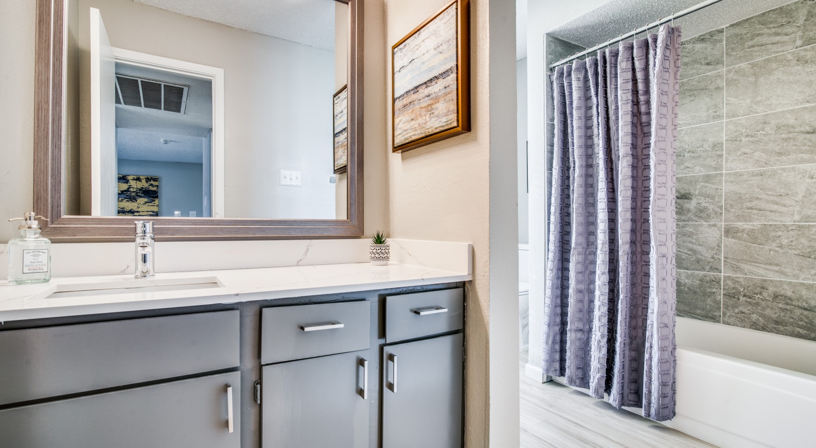 a bathroom with a shower and sink and a mirror at The  Durham
