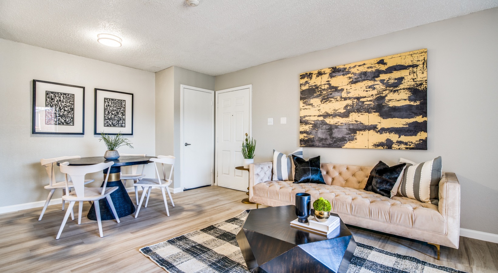 a living room with a couch, coffee table and chairs at The  Durham