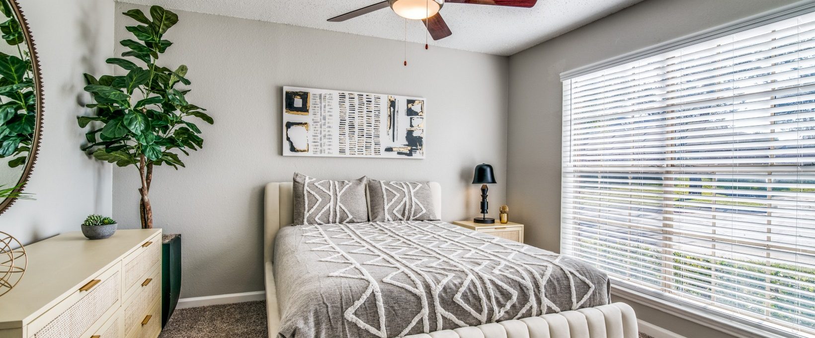 a bedroom with a ceiling fan and white bed at The  Durham
