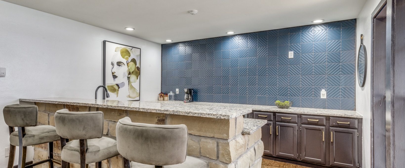 a kitchen with a bar and blue tile at The  Durham