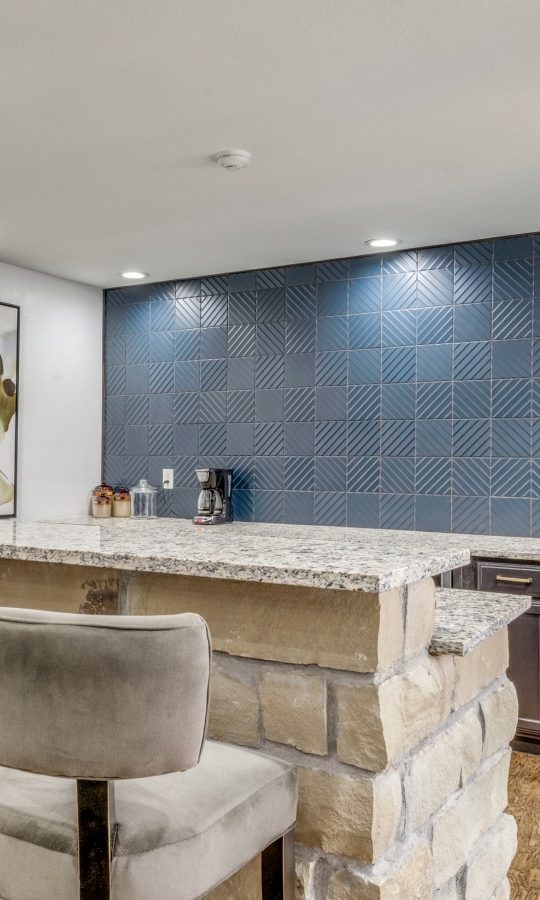 a kitchen with a bar and blue tile at The  Durham