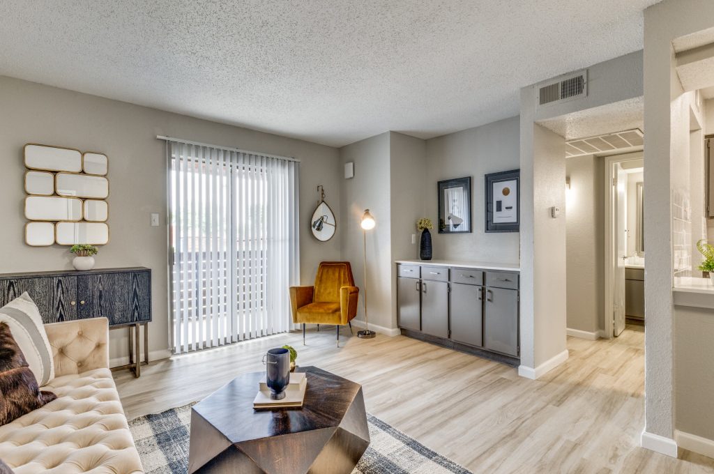 the living room has hardwood floors and a large window at The  Durham