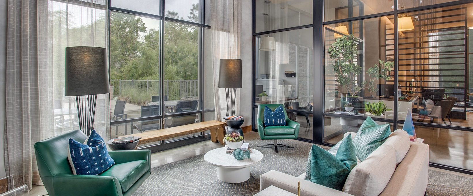 a living room with large windows and a couch at The Twin Creeks Crossing