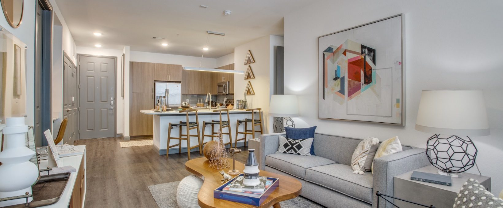 a living room with a couch, coffee table and a television at The Twin Creeks Crossing