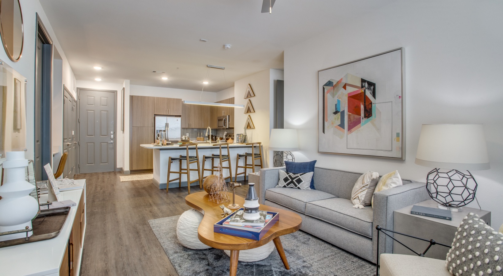 a living room with a couch, coffee table and a television at The Twin Creeks Crossing