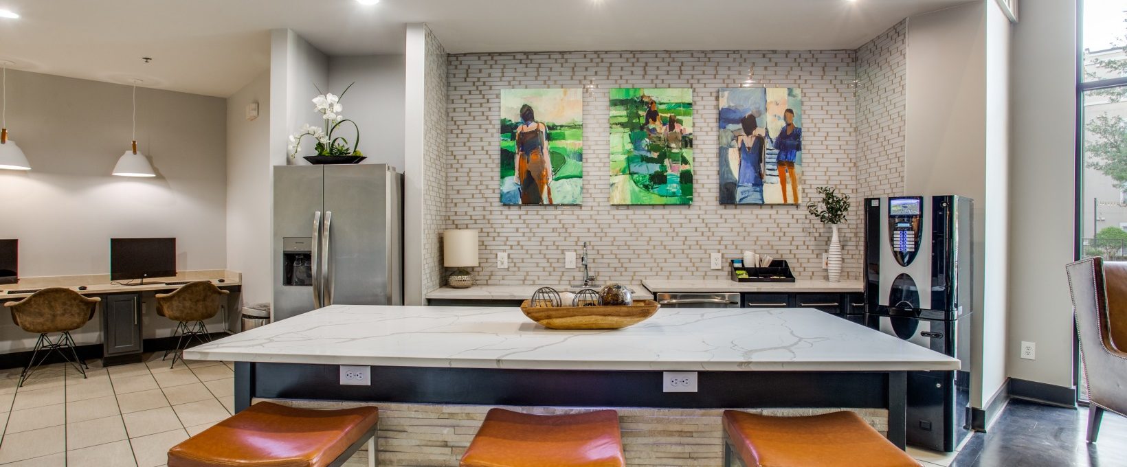 a kitchen with a large island and bar stools at The  Franklin at Samuels Ave