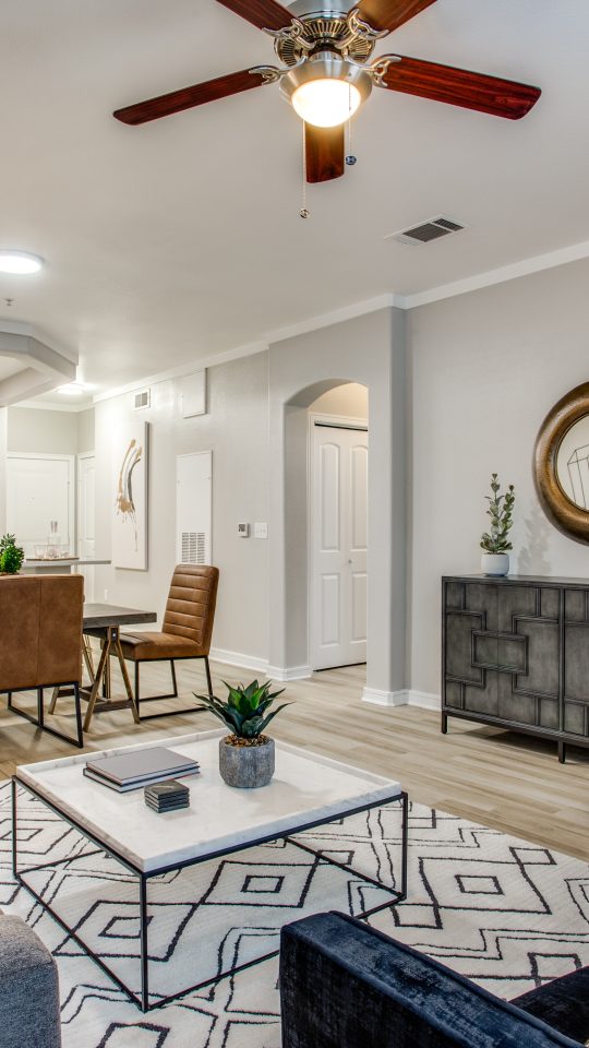 a living room with a ceiling fan and a couch at The  Franklin at Samuels Ave