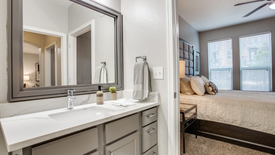 a bathroom with a sink, mirror and vanity at The  Franklin at Samuels Ave
